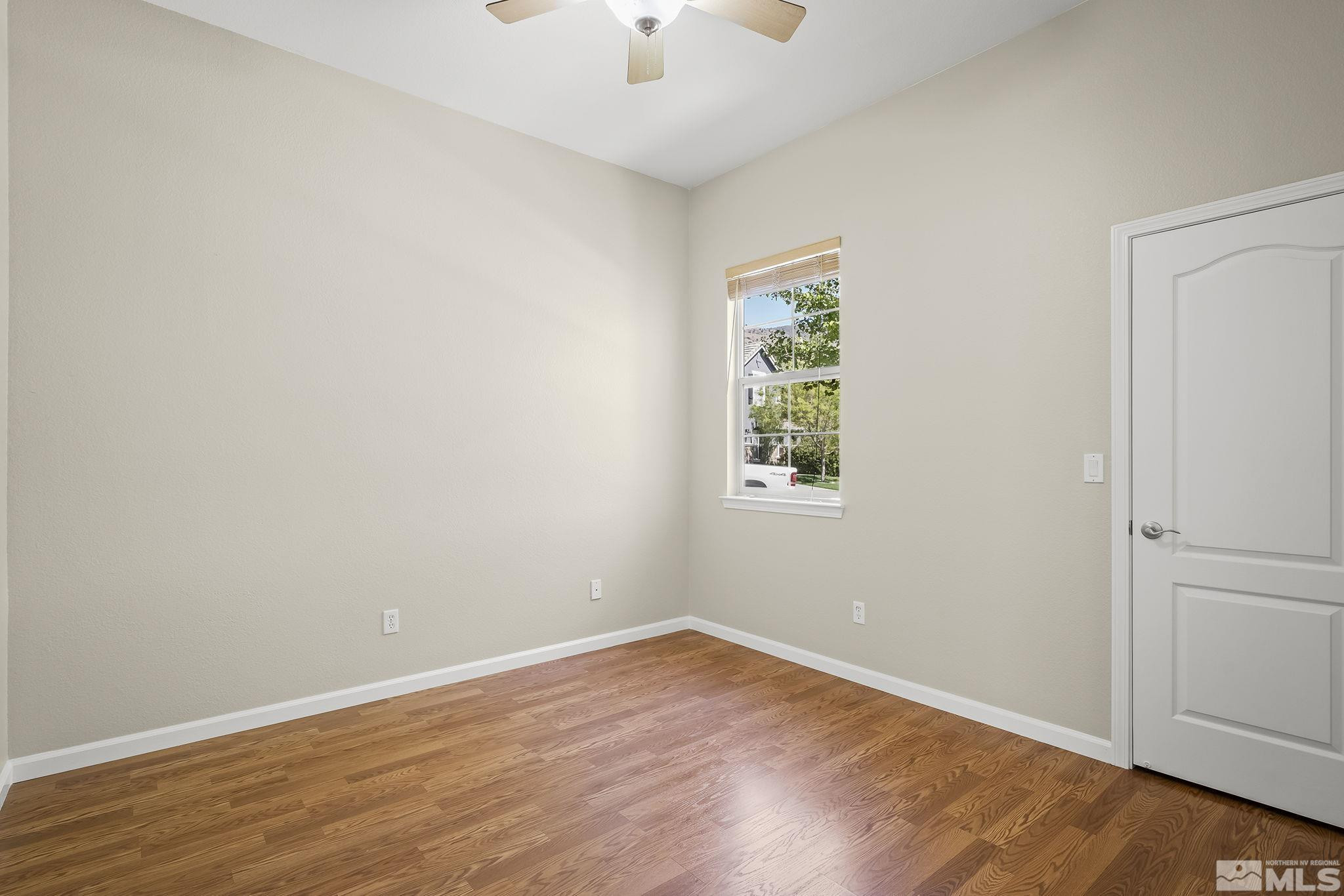 2685 Alder Bridge Court Reno, NV 89521 - Photo 20 of 38 an empty room with a window and wooden floor