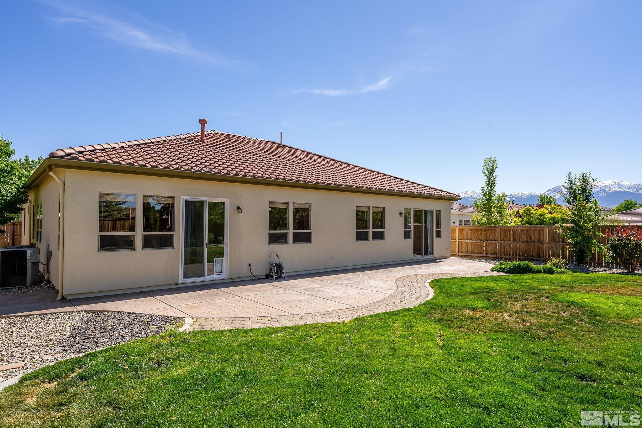 2685 Alder Bridge Court Reno, NV 89521 - Photo 25 of 38 a front view of a house with a garden and yard