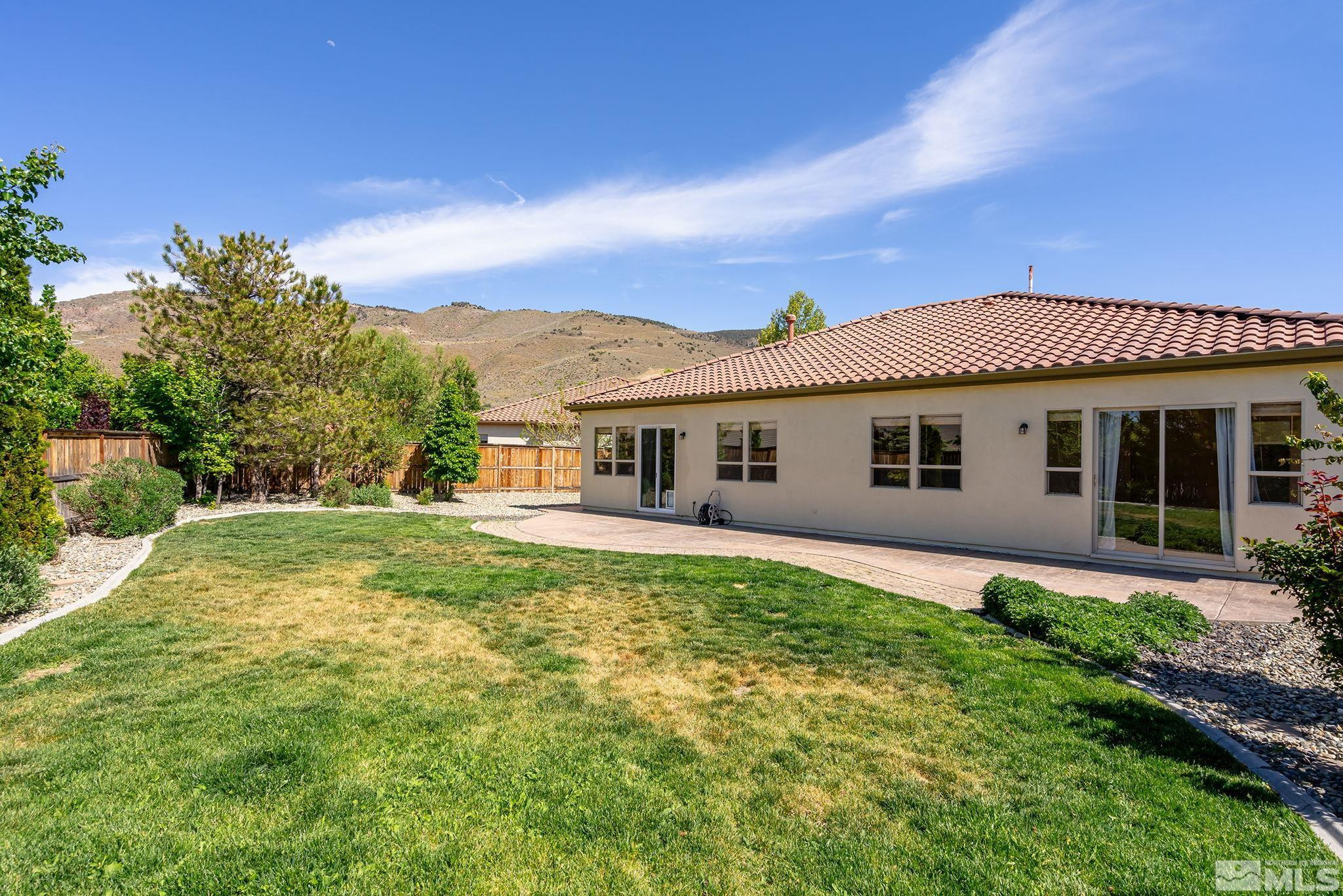 2685 Alder Bridge Court Reno, NV 89521 - Photo 27 of 38 a front view of a house with a garden