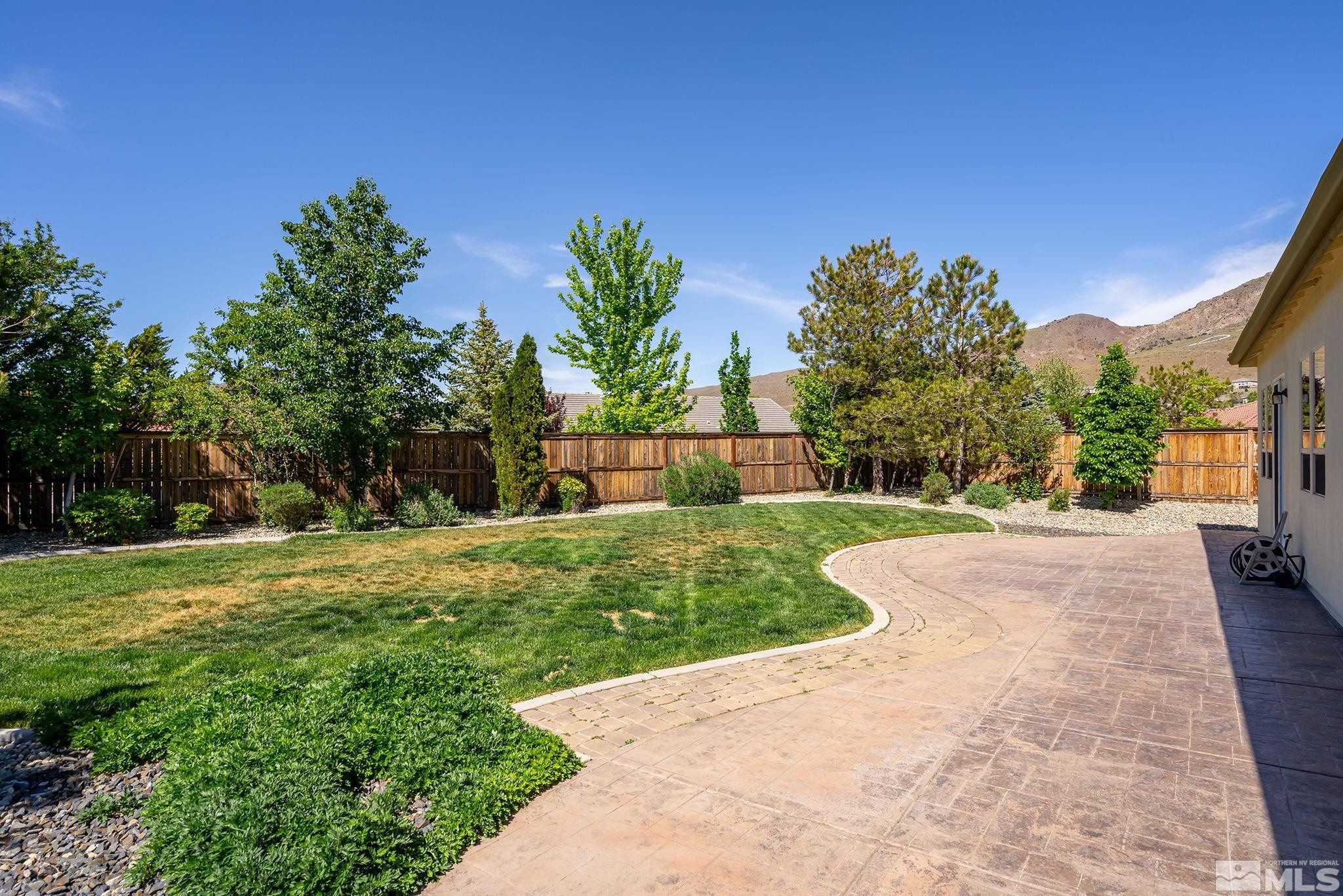 2685 Alder Bridge Court Reno, NV 89521 - Photo 29 of 38 a view of a garden with a building in the background