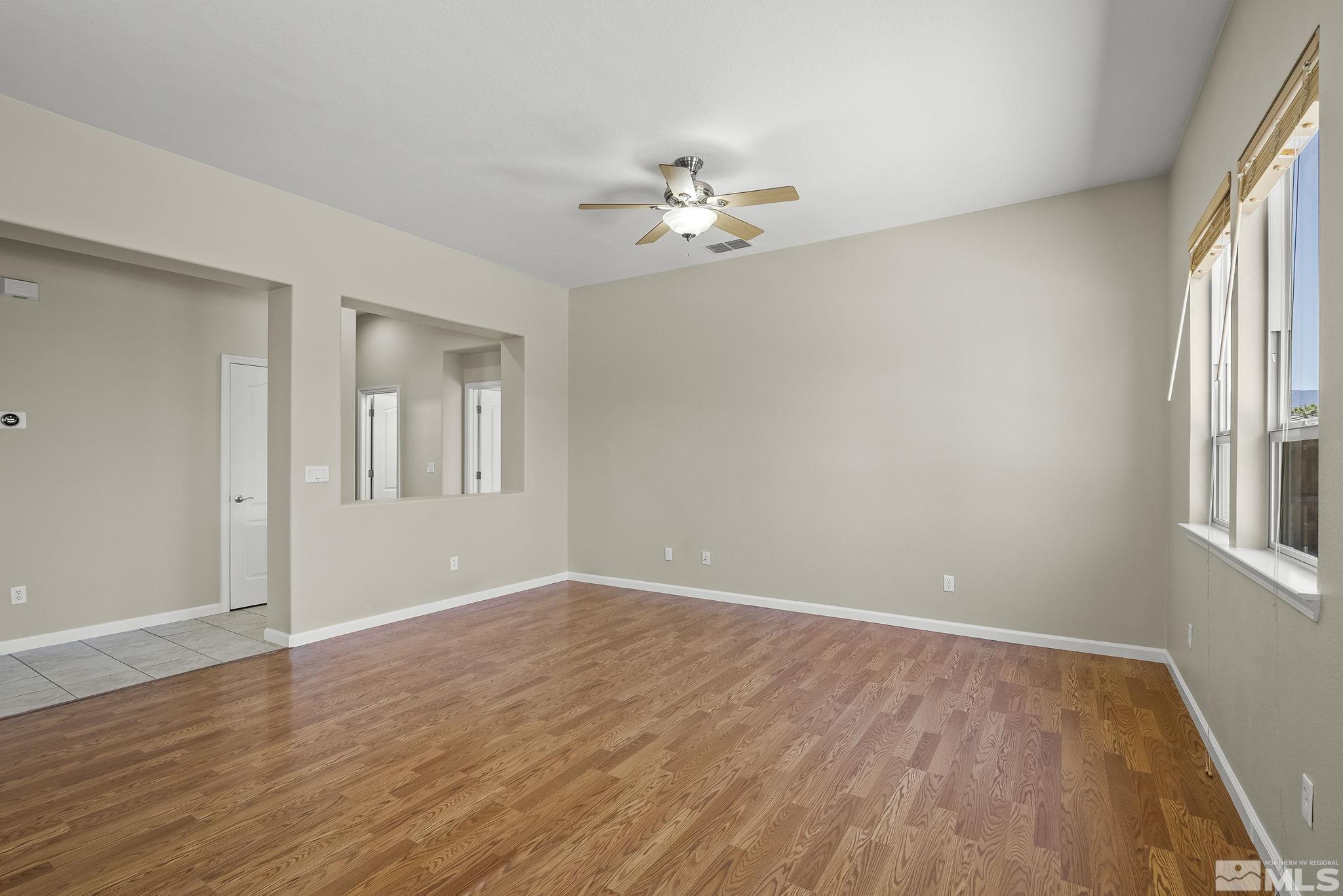 2685 Alder Bridge Court Reno, NV 89521 - Photo 6 of 38 wooden floor in an empty room with a window