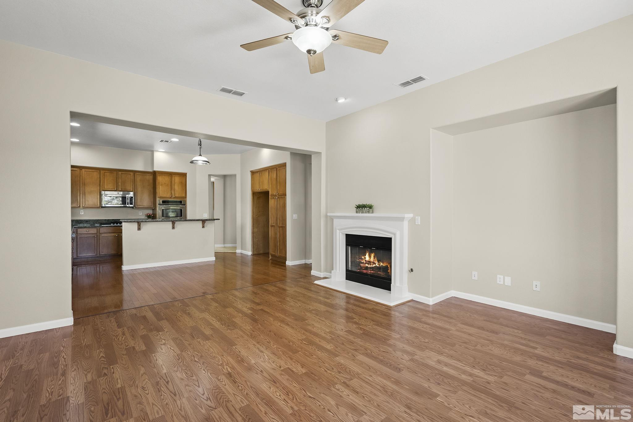 2685 Alder Bridge Court Reno, NV 89521 - Photo 8 of 38 a view of a kitchen with a sink and a fireplace