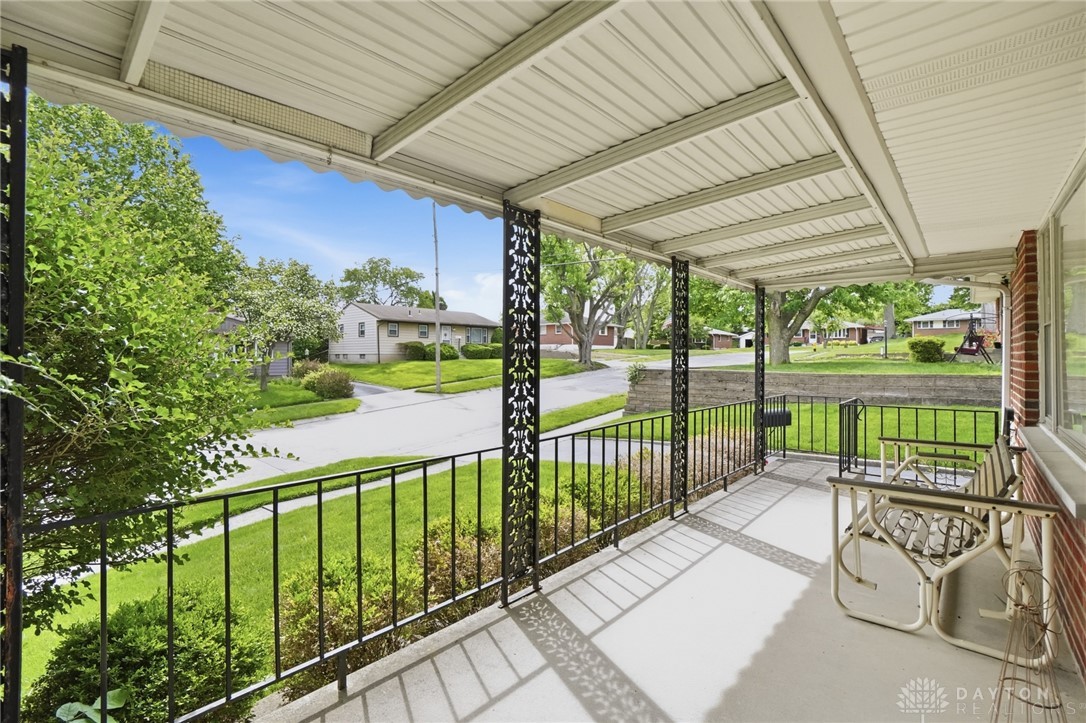 877 Woodhill Road Riverside, OH 45431 - Photo 5 of 42 Enjoy tranquil moments on this welcoming covered front porch, perfect for relaxation.