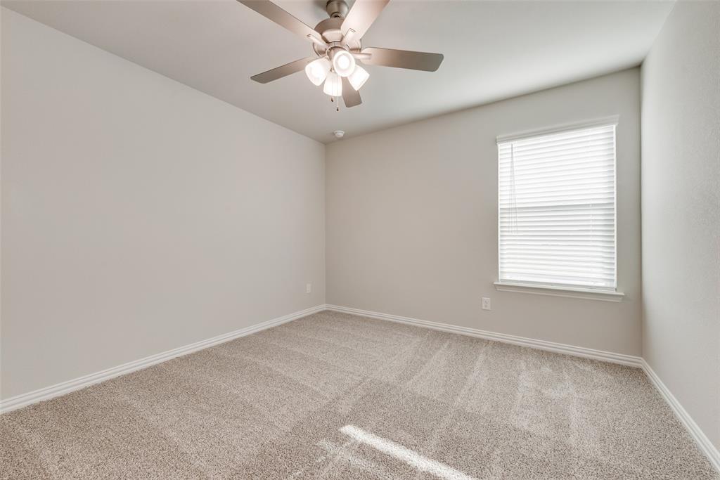 232 Sutter Mill Road Saginaw, TX 76131 - Photo 12 of 24 an empty room with a window and a fan