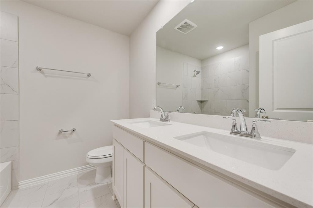 232 Sutter Mill Road Saginaw, TX 76131 - Photo 13 of 24 a bathroom with a sink toilet and shower