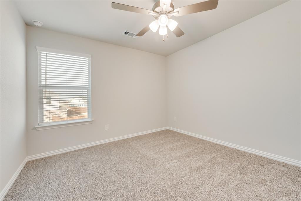 232 Sutter Mill Road Saginaw, TX 76131 - Photo 15 of 24 an empty room with a window and a fan