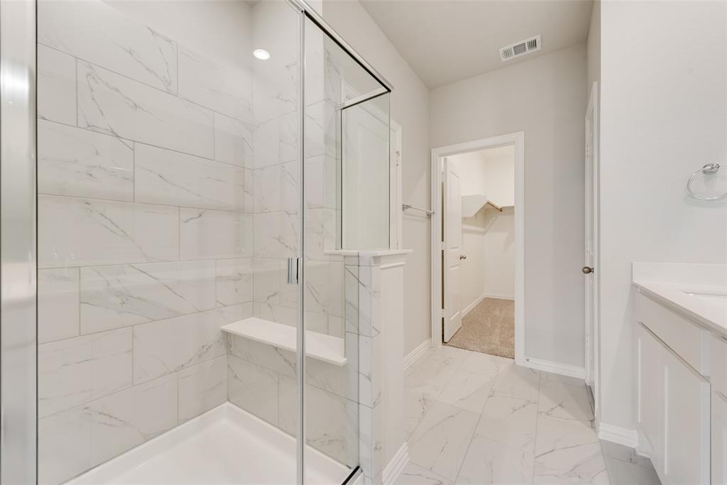 232 Sutter Mill Road Saginaw, TX 76131 - Photo 19 of 24 a bathroom with a shower and a glass door