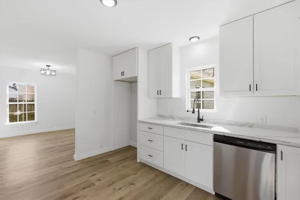 a kitchen with a sink cabinets and window