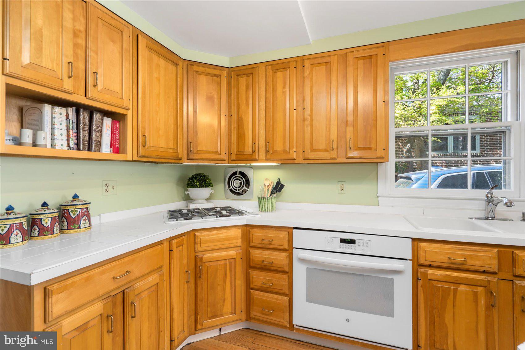 600 Somerset Road Baltimore, MD 21210 - Photo 15 of 59 a kitchen with stainless steel appliances granite countertop a sink a stove cabinets and a window