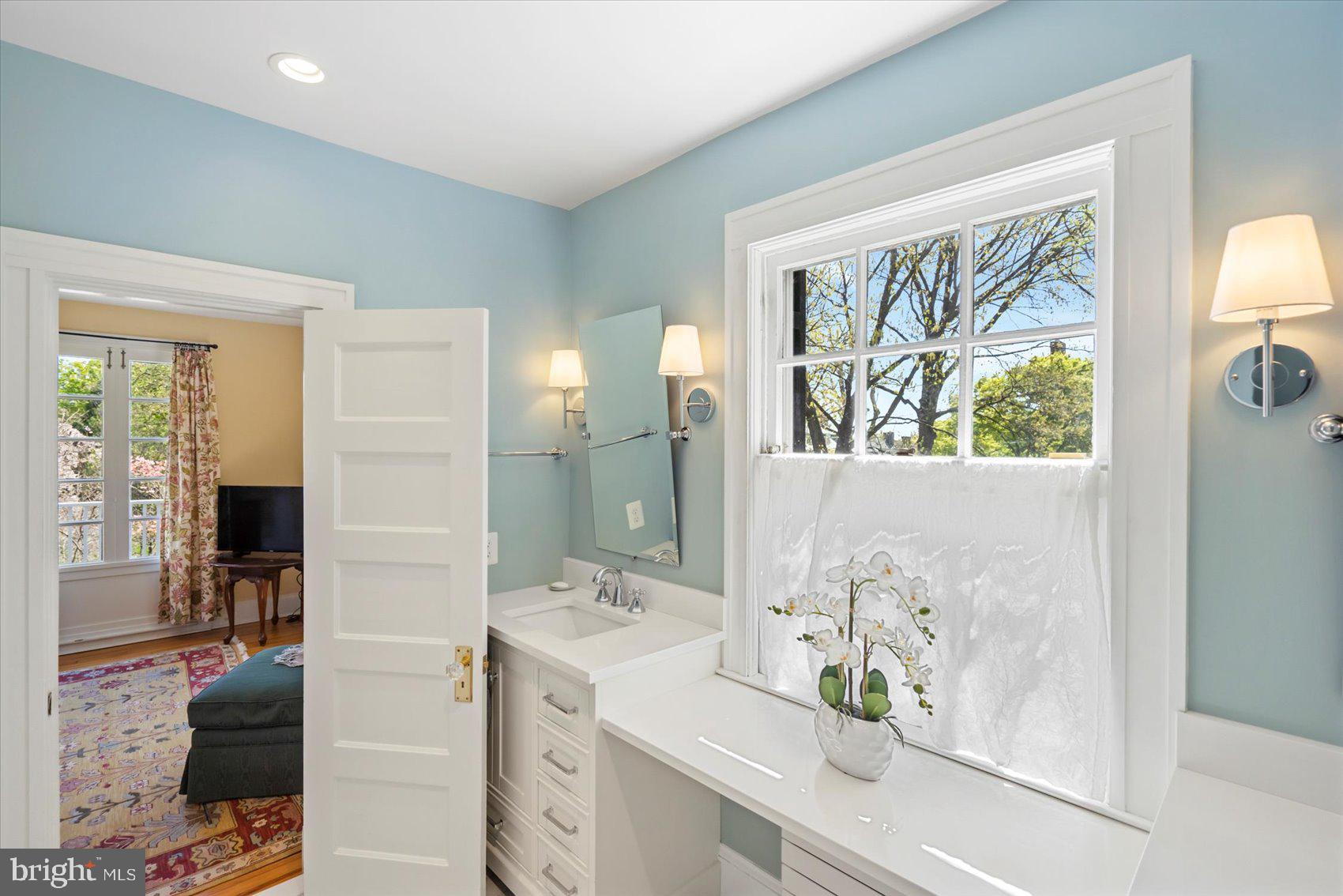 600 Somerset Road Baltimore, MD 21210 - Photo 32 of 59 a spacious bathroom with a granite countertop sink and a large mirror