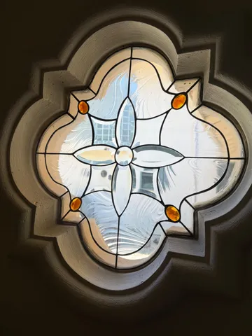 a living room with fireplace furniture and a large window