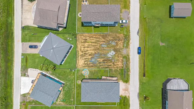 view of houses with outdoor space and a car parked
