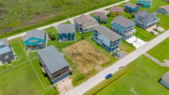 an aerial view of a house with a garden and swimming pool