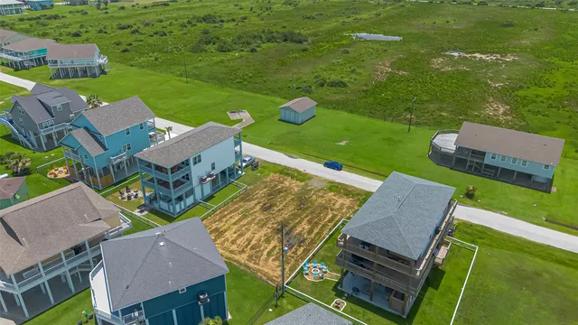 an aerial view of a house with swimming pool garden and patio