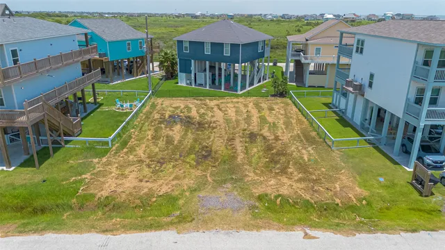a view of a yard with plants and a table