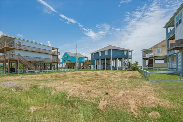 a front view of a house with a yard and balcony