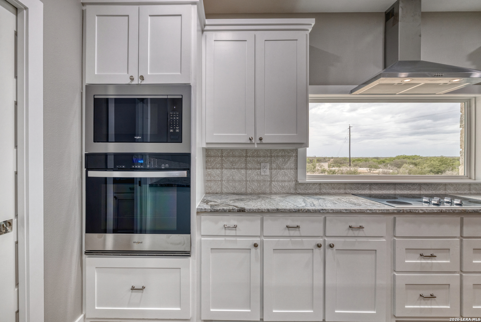 22 Greystone Hills Uvalde, TX 78801 - Photo 47 of 68 a kitchen with granite countertop white cabinets and a stove