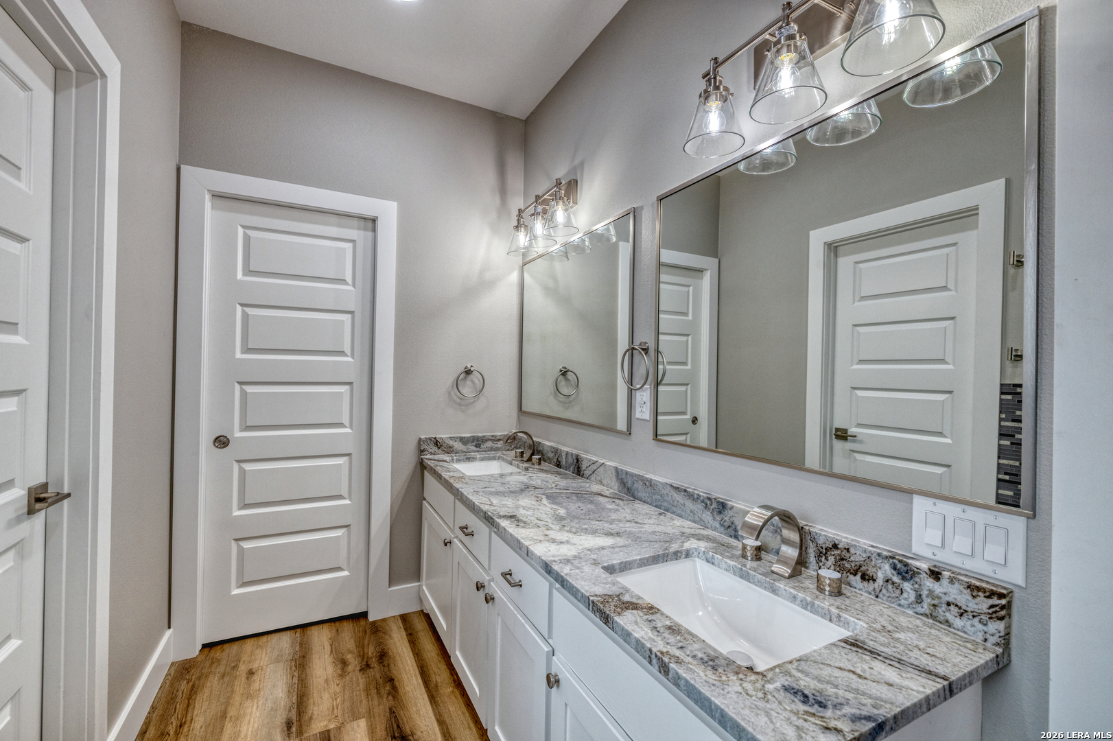 22 Greystone Hills Uvalde, TX 78801 - Photo 55 of 68 a bathroom with a granite countertop sink a mirror and a shower