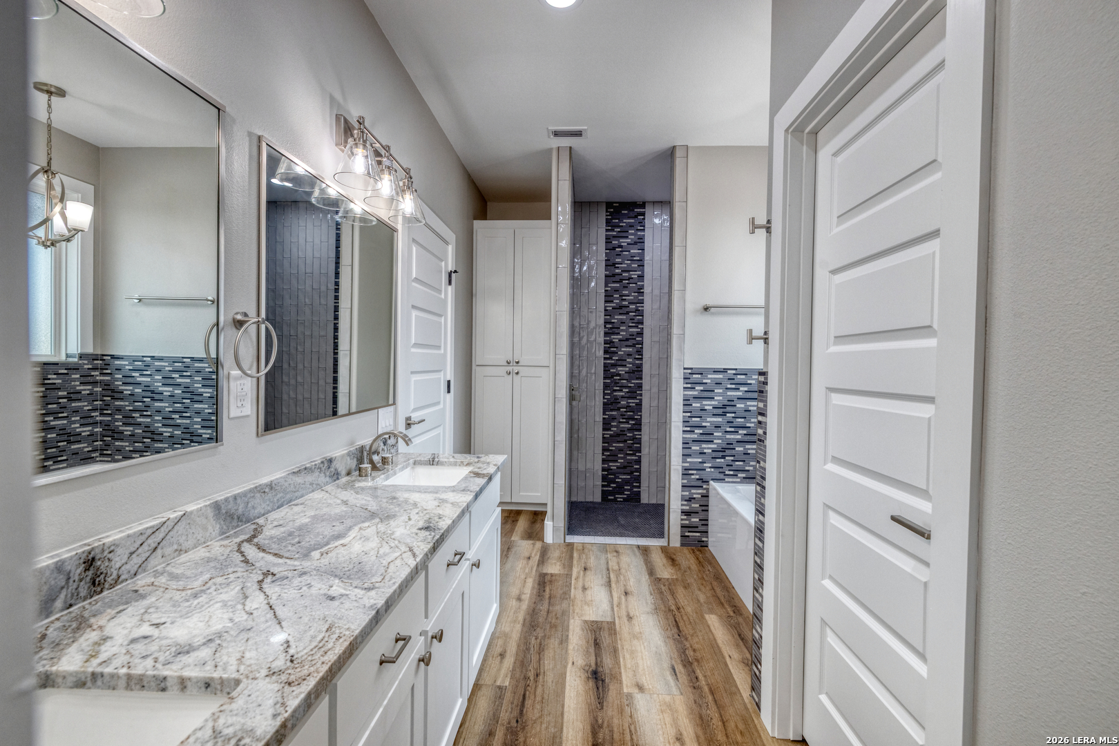 22 Greystone Hills Uvalde, TX 78801 - Photo 58 of 68 a spacious bathroom with a granite countertop sink a mirror and shower