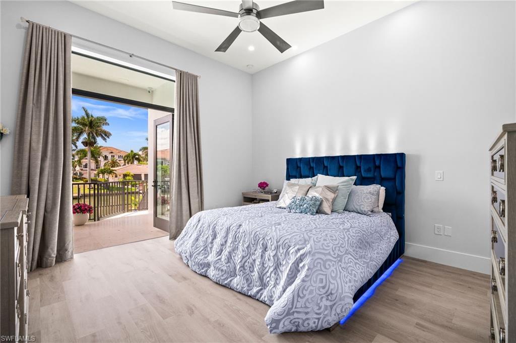 388 Pine Avenue Naples, FL 34108 - Photo 21 of 34 a bedroom with a bed and a chandelier