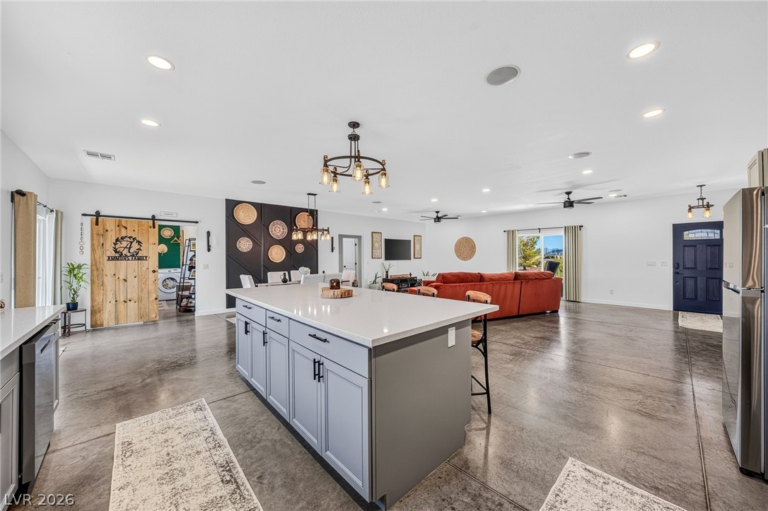 4080 Magnet Road Pahrump, NV 89048 - Photo 4 of 28 Polished concrete floors and recessed lighting anchor this expansive open-concept living space.