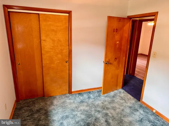 a view of hallway with wooden floor