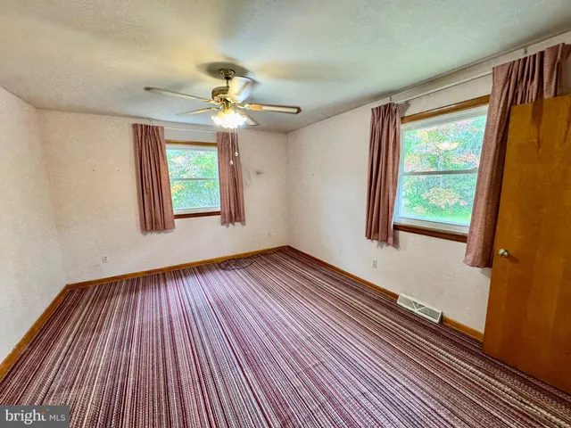 a bathroom with a toilet a sink and a mirror