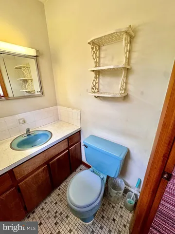 a bathroom with a sink toilet a mirror and shower