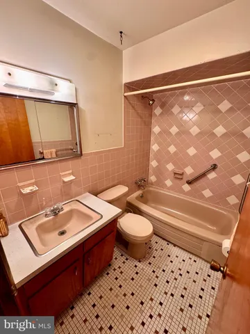 a bathroom with a toilet and a shower curtain