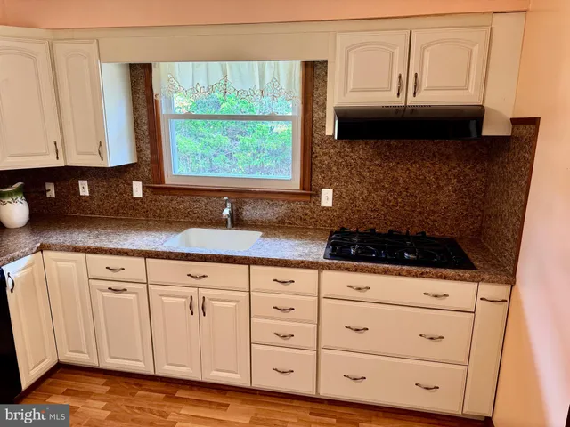 a view of a kitchen with microwave and refrigerator