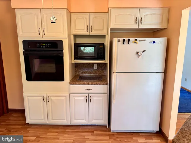 a kitchen with granite countertop a stove fireplace and cabinets