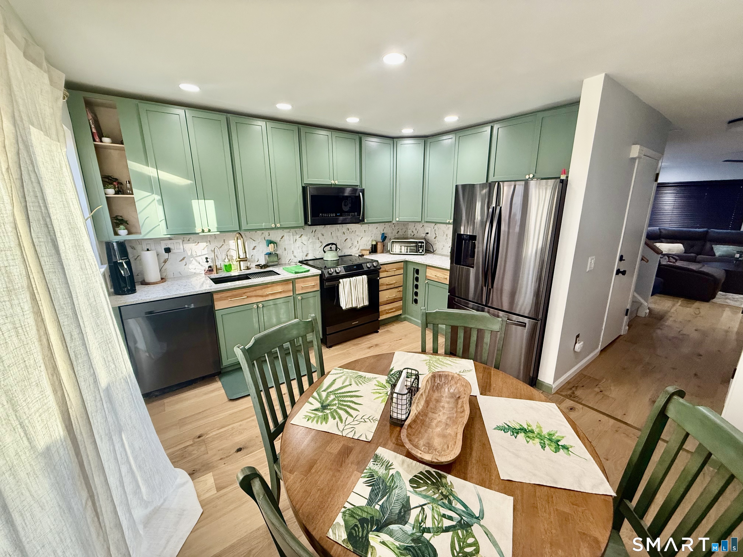 14 Sunrise Hill Road, Unit 14 Norwalk, CT 06851 - Photo 11 of 23 a kitchen with stainless steel appliances granite countertop a refrigerator a stove top oven a sink dishwasher and dining table