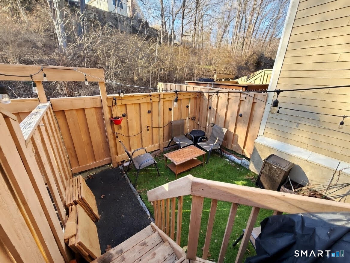 14 Sunrise Hill Road, Unit 14 Norwalk, CT 06851 - Photo 13 of 23 a view of a deck with wooden fence and floor