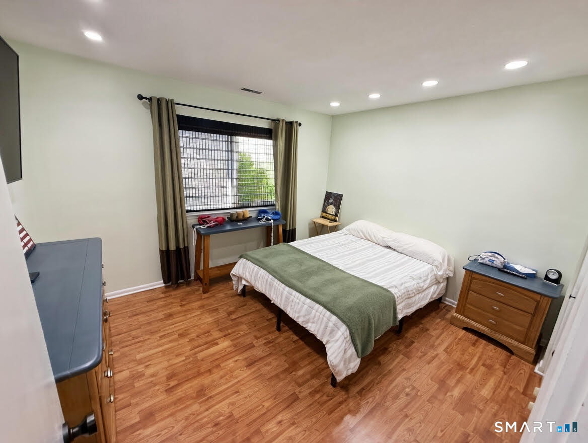 14 Sunrise Hill Road, Unit 14 Norwalk, CT 06851 - Photo 16 of 23 a bedroom with a bed and chair