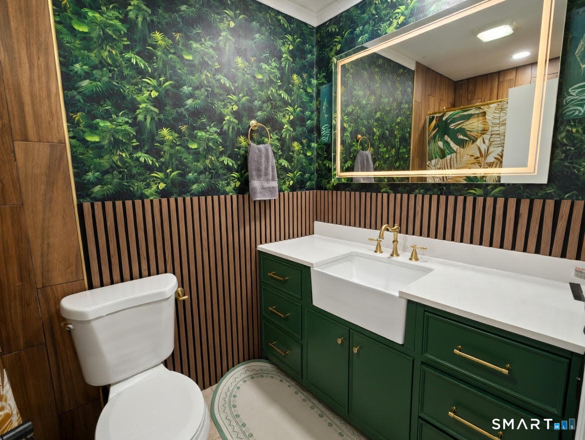 14 Sunrise Hill Road, Unit 14 Norwalk, CT 06851 - Photo 17 of 23 a bathroom with a toilet sink and mirror