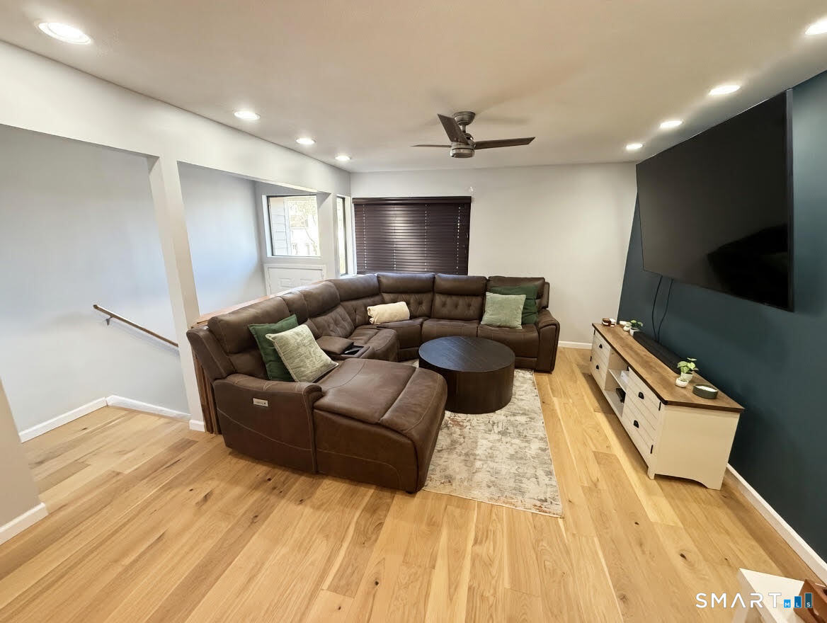 14 Sunrise Hill Road, Unit 14 Norwalk, CT 06851 - Photo 6 of 23 a living room with furniture and a flat screen tv