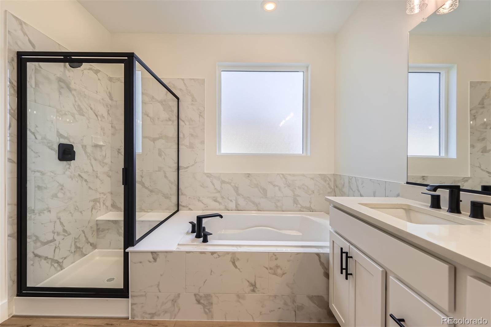 42979 Colonial Trail Elizabeth, CO 80107 - Photo 20 of 32 a bathroom with a tub sink and mirror