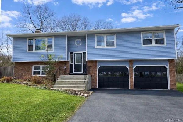 a large bedroom with a bed and wooden floor