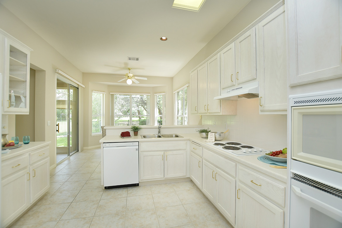 114 Lone Star Drive Georgetown, TX 78633 - Photo 12 of 30 A well-lit kitchen with generous cabinetry and an inviting breakfast bar opens to the cheerful breakfast area.