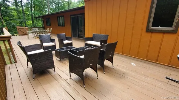 a view of a patio with table and chairs with wooden floor