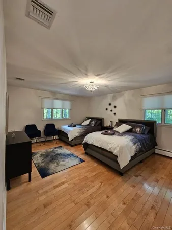 a bedroom with furniture and a potted plant