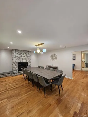 a living room with furniture a fireplace and kitchen view