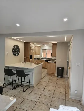 a large kitchen with a counter space and appliances