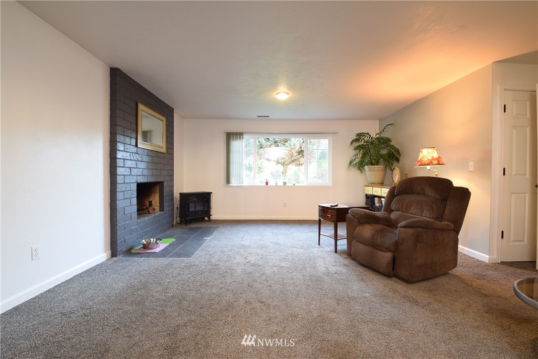 2631 166th Street Southeast Bothell, WA 98012 - Photo 11 of 18 a living room with furniture and a fireplace