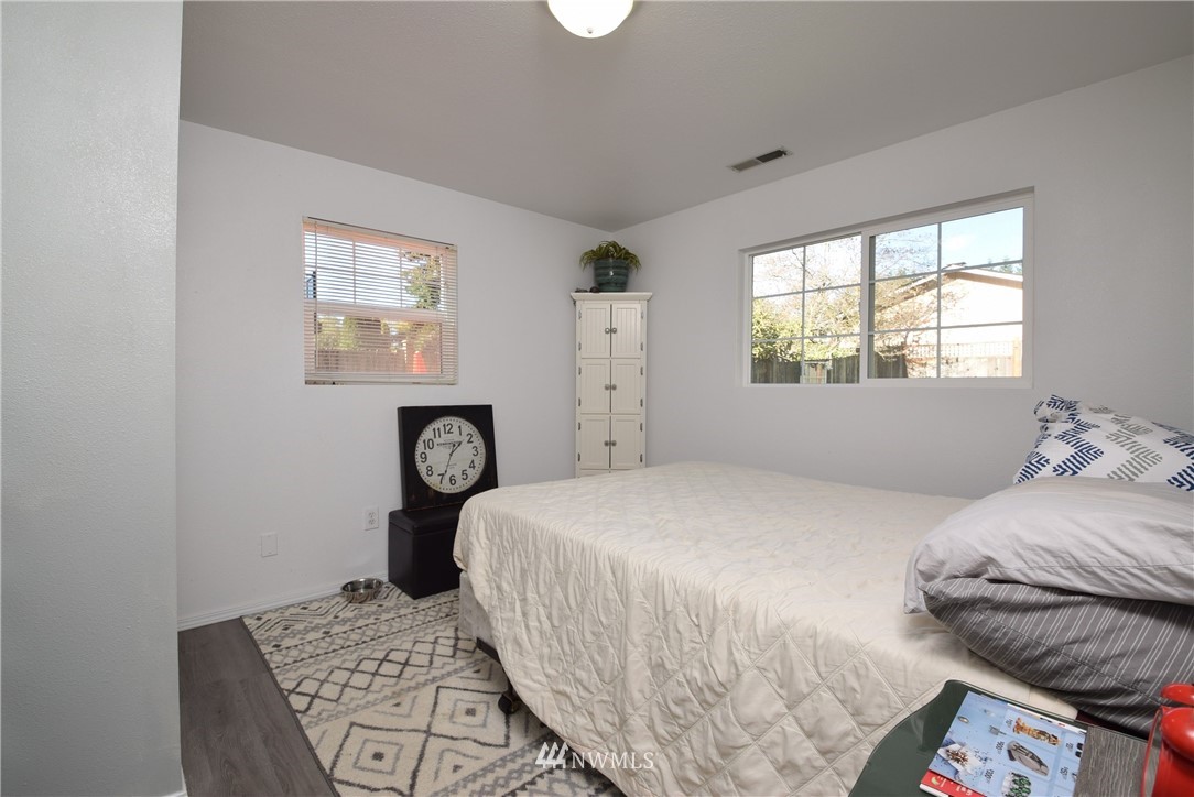 2631 166th Street Southeast Bothell, WA 98012 - Photo 15 of 18 a bedroom with a bed and a table in it