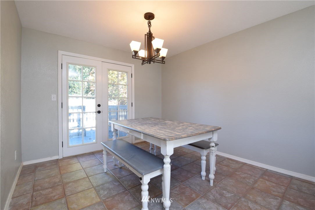 2631 166th Street Southeast Bothell, WA 98012 - Photo 6 of 18 a room with chandelier table and windows
