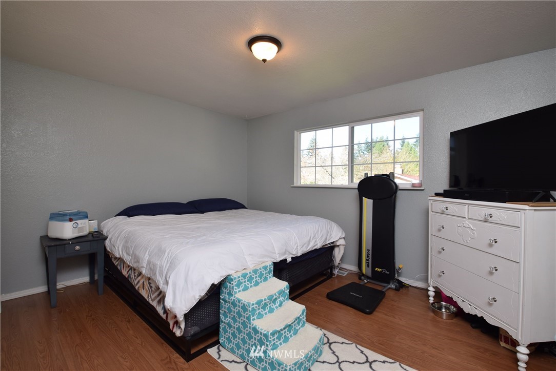 2631 166th Street Southeast Bothell, WA 98012 - Photo 8 of 18 a bedroom with a bed and a flat screen tv