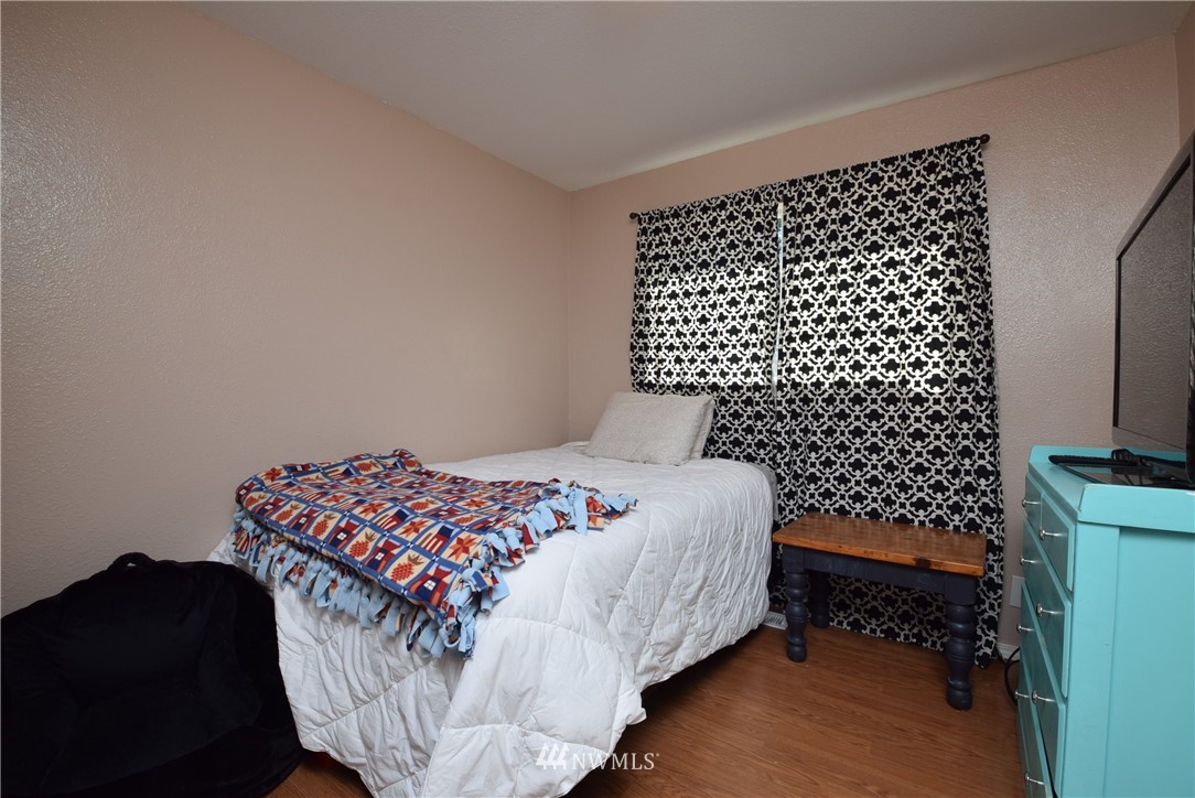 2631 166th Street Southeast Bothell, WA 98012 - Photo 10 of 18 a bedroom with a bed and a wall painting