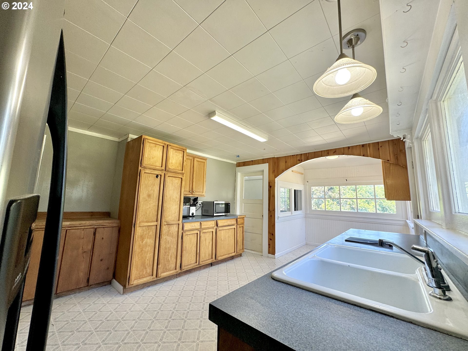 1463 Southside Road Sutherlin, OR 97479 - Photo 7 of 48 a kitchen with sink refrigerator and window