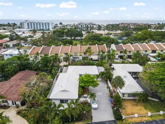 an aerial view of residential houses with outdoor space